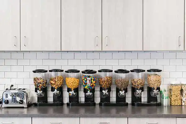 A row of snack dispensers with various nuts and chips in the Name.com kitchen A row of snack dispensers with various nuts and chips in the Name.com kitchen