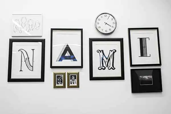 A series of picture frames on a wall that have the letters that spell out Name A series of picture frames on a wall that have the letters that spell out Name